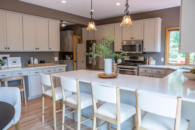 2505 Christian Dr, Chaska, MN 55318 - kitchen featuring stainless steel appliances, recessed lighting, decorative light fixtures, light countertops, and white cabinets