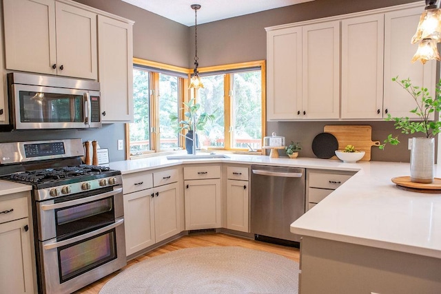 2505 Christian Dr, Chaska, MN 55318 - kitchen featuring appliances with stainless steel finishes, light countertops, and pendant lighting