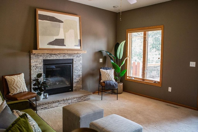 2505 Christian Dr, Chaska, MN 55318 - living area featuring carpet flooring, baseboards, ceiling fan, and a stone fireplace
