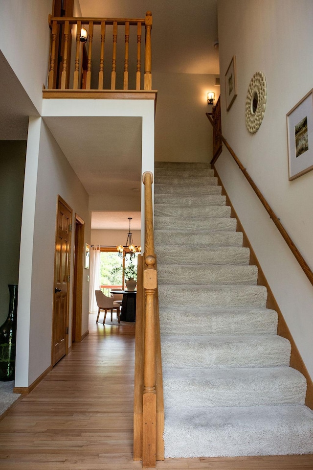 2505 Christian Dr, Chaska, MN 55318 - staircase with a chandelier, wood finished floors, and baseboards