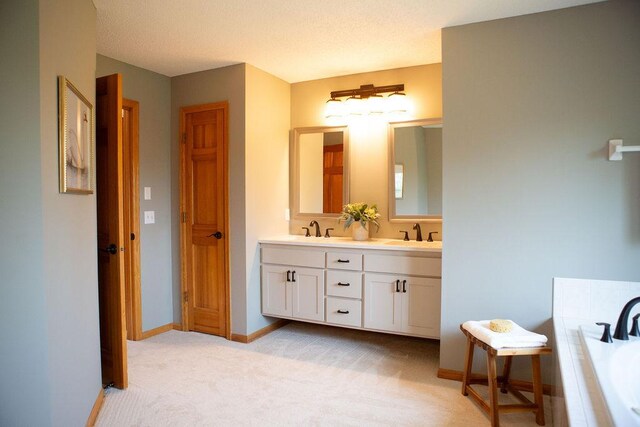 2505 Christian Dr, Chaska, MN 55318 - bathroom featuring double vanity, a bath, and baseboards