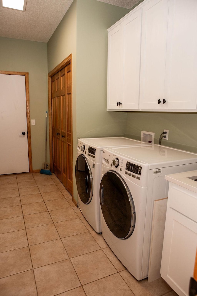 2505 Christian Dr, Chaska, MN 55318 - laundry area with cabinet space, washing machine and clothes dryer, light tile patterned floors, and a textured ceiling
