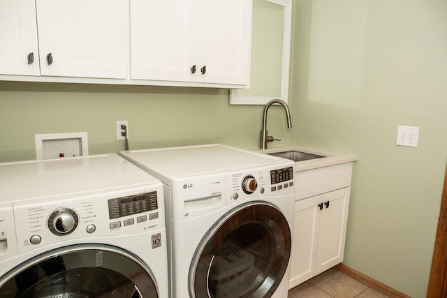 2505 Christian Dr, Chaska, MN 55318 - laundry area featuring washing machine and clothes dryer, cabinet space, light tile patterned floors, and baseboards