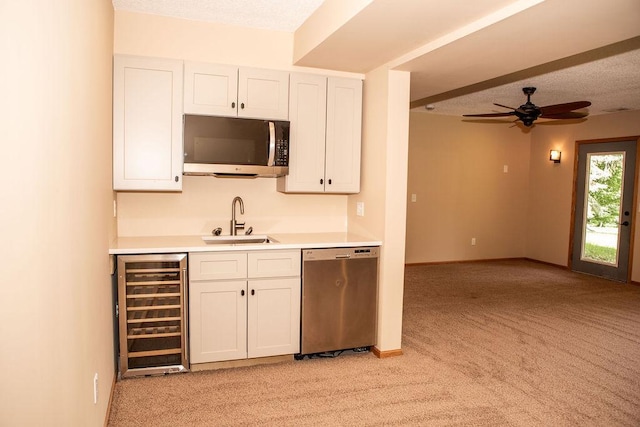 2505 Christian Dr, Chaska, MN 55318 - kitchen with stainless steel appliances, beverage cooler, a sink, and light carpet