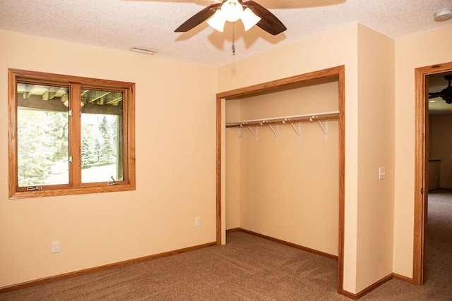 2505 Christian Dr, Chaska, MN 55318 - unfurnished bedroom with carpet, a closet, a textured ceiling, baseboards, and ceiling fan
