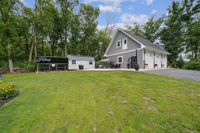 2293 57th Ave, East Farmington, WI 54020 - view of front facade with a front lawn, a garage, a storage unit, and gravel driveway