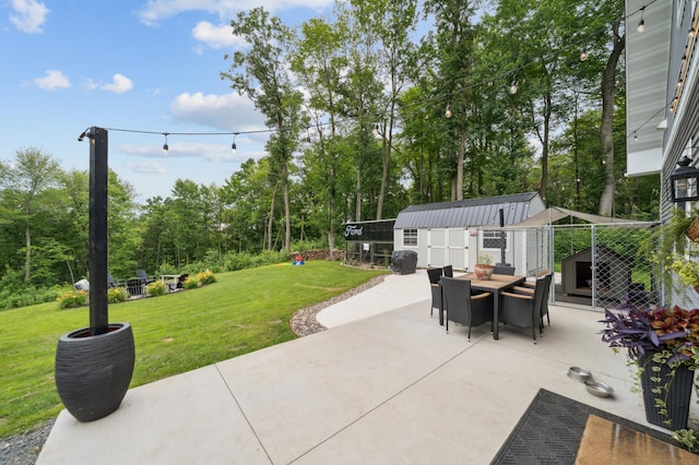 2293 57th Ave, East Farmington, WI 54020 - view of patio featuring a storage unit, outdoor dining area, and view of scattered trees