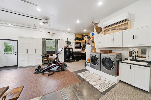 2293 57th Ave, East Farmington, WI 54020 - laundry room featuring washing machine and clothes dryer, cabinet space, a wall mounted AC, plenty of natural light, and recessed lighting