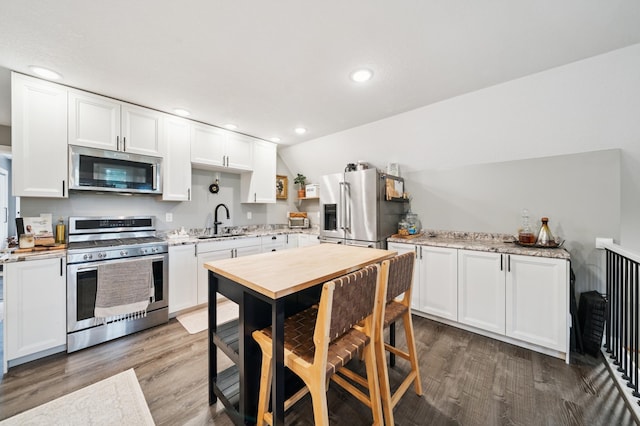 2293 57th Ave, East Farmington, WI 54020 - kitchen featuring stainless steel appliances, wood finished floors, white cabinetry, and recessed lighting