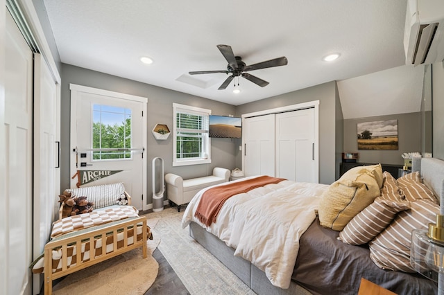 2293 57th Ave, East Farmington, WI 54020 - bedroom featuring an AC wall unit, recessed lighting, wood finished floors, and a ceiling fan