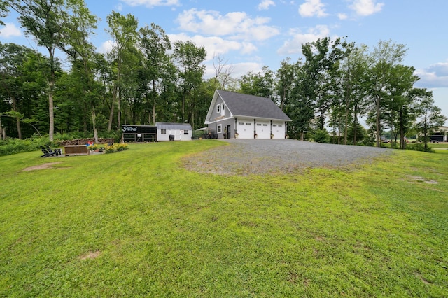 2293 57th Ave, East Farmington, WI 54020 - view of green lawn featuring driveway, a garage, and an outbuilding