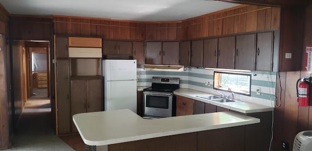 11347 3rd St NE, Blaine, MN 55434 - kitchen featuring stainless steel range with electric stovetop, freestanding refrigerator, a sink, light countertops, and a peninsula
