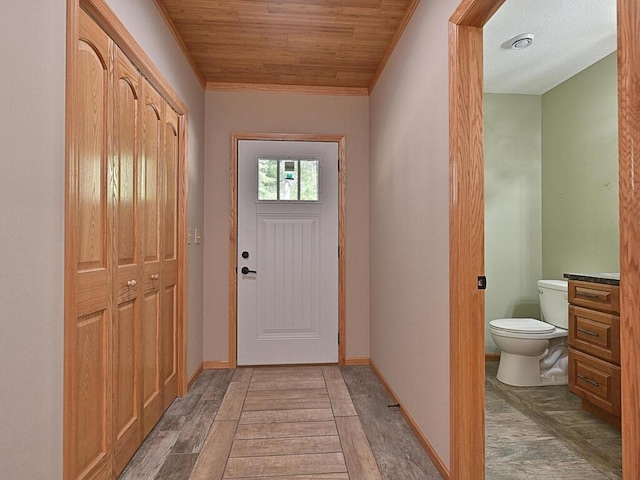 33272 Big Pine Trl, Grand Rapids, MN 55744 - entryway with crown molding, wood ceiling, light wood-style flooring, and baseboards
