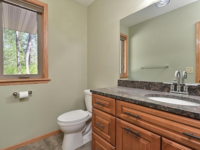 33272 Big Pine Trl, Grand Rapids, MN 55744 - bathroom featuring toilet, vanity, and baseboards