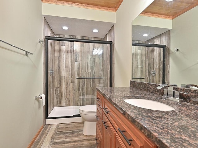 33272 Big Pine Trl, Grand Rapids, MN 55744 - full bath with ornamental molding, a shower stall, toilet, vanity, and wood finished floors