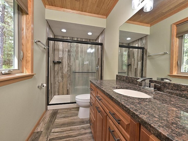 33272 Big Pine Trl, Grand Rapids, MN 55744 - bathroom featuring ornamental molding, a shower stall, toilet, wood finished floors, and vanity