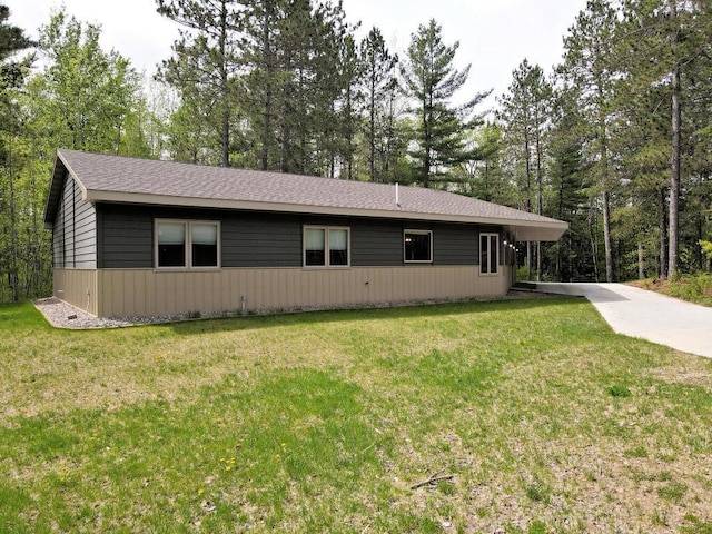 33272 Big Pine Trl, Grand Rapids, MN 55744 - view of front facade with a front lawn, concrete driveway, and roof with shingles