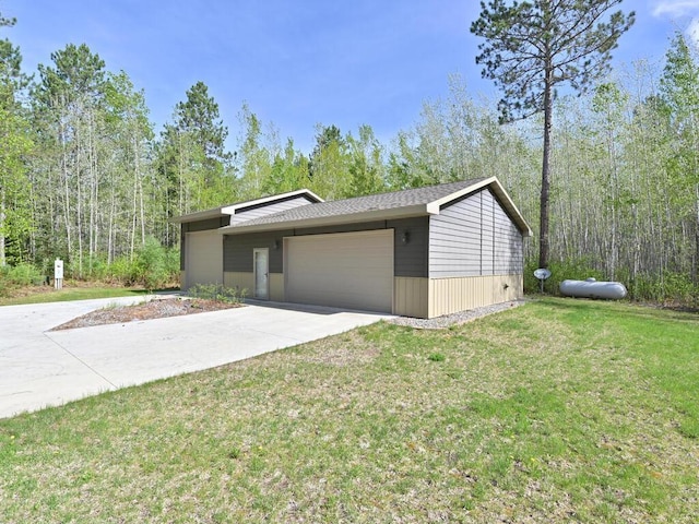 33272 Big Pine Trl, Grand Rapids, MN 55744 - view of home's exterior with a lawn, an attached garage, and driveway