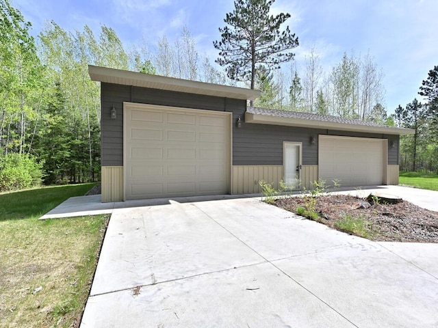 33272 Big Pine Trl, Grand Rapids, MN 55744 - view of front of property with driveway, a garage, and a front lawn