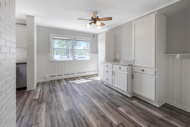 30105 Olinda Trl, Lindstrom, MN 55045 - unfurnished dining area with a baseboard radiator, wainscoting, a ceiling fan, dark wood finished floors, and crown molding