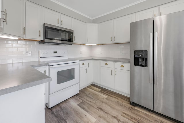 30105 Olinda Trl, Lindstrom, MN 55045 - kitchen with appliances with stainless steel finishes, crown molding, white cabinetry, decorative backsplash, and light wood-style floors