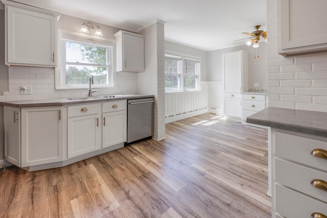 30105 Olinda Trl, Lindstrom, MN 55045 - kitchen with dishwasher, a sink, baseboard heating, ceiling fan, and light wood-style floors