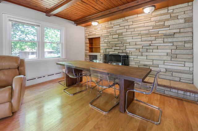 30105 Olinda Trl, Lindstrom, MN 55045 - dining room featuring baseboard heating, wooden ceiling, a fireplace, wood finished floors, and beamed ceiling