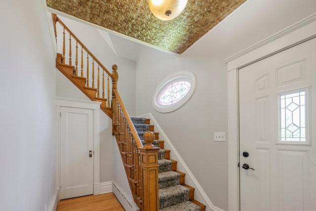 30105 Olinda Trl, Lindstrom, MN 55045 - entryway featuring stairway, light wood-style floors, a baseboard radiator, an ornate ceiling, and baseboards