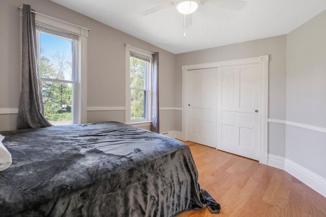 30105 Olinda Trl, Lindstrom, MN 55045 - bedroom with wood finished floors, a ceiling fan, baseboards, and a closet