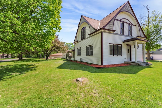 30105 Olinda Trl, Lindstrom, MN 55045 - view of side of home with a shingled roof and a lawn