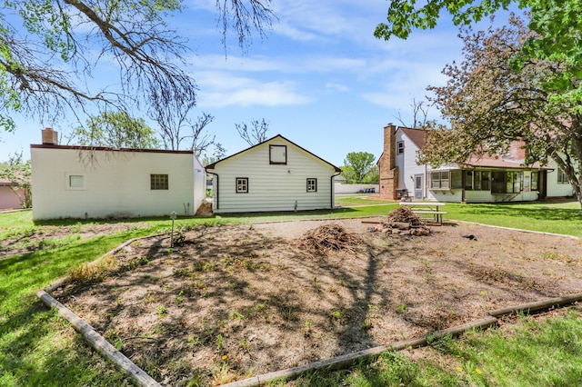 30105 Olinda Trl, Lindstrom, MN 55045 - rear view of property featuring a sunroom and a lawn