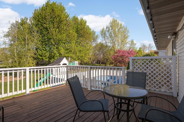 409 5th St NW, Saint Michael, MN 55376 - wooden deck featuring a storage unit and an outdoor structure