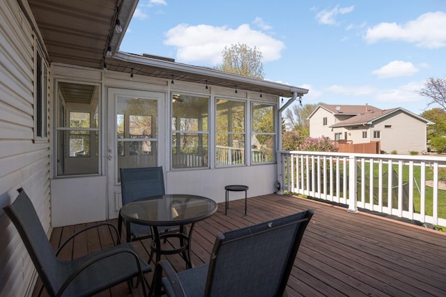 409 5th St NW, Saint Michael, MN 55376 - wooden deck featuring outdoor dining space and a sunroom
