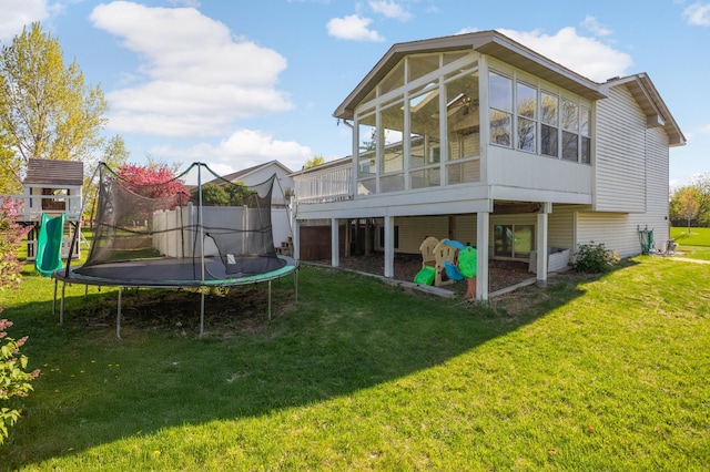 409 5th St NW, Saint Michael, MN 55376 - rear view of property featuring a trampoline, a yard, and a sunroom