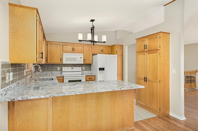 409 5th St NW, Saint Michael, MN 55376 - kitchen featuring white appliances, a sink, a peninsula, light wood finished floors, and backsplash
