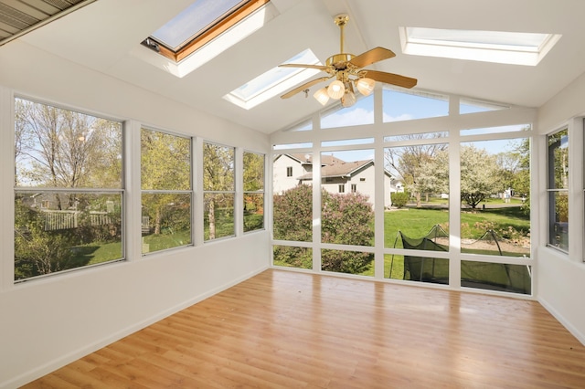 409 5th St NW, Saint Michael, MN 55376 - unfurnished sunroom featuring a skylight, lofted ceiling, wood finished floors, and baseboards