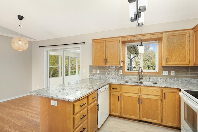 409 5th St NW, Saint Michael, MN 55376 - kitchen with a sink, white appliances, a peninsula, vaulted ceiling, and tasteful backsplash