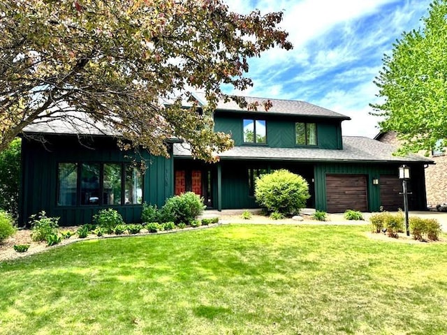 1108 Maple St, Alexandria, MN 56308 - view of front of home featuring a front lawn, a garage, and board and batten siding