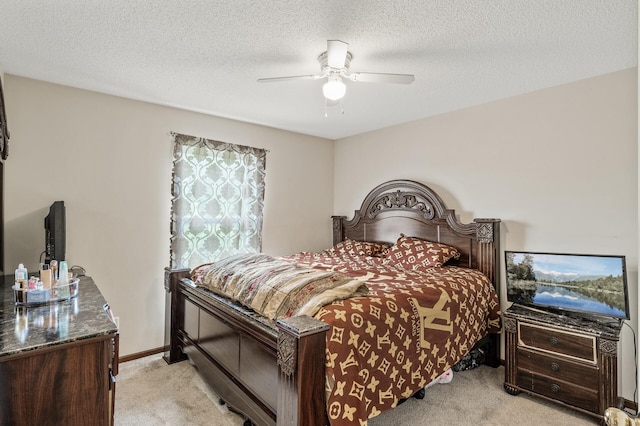 bedroom with light carpet, a ceiling fan, a textured ceiling, and baseboards