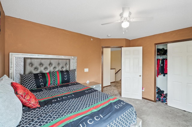 carpeted bedroom with ceiling fan and a closet
