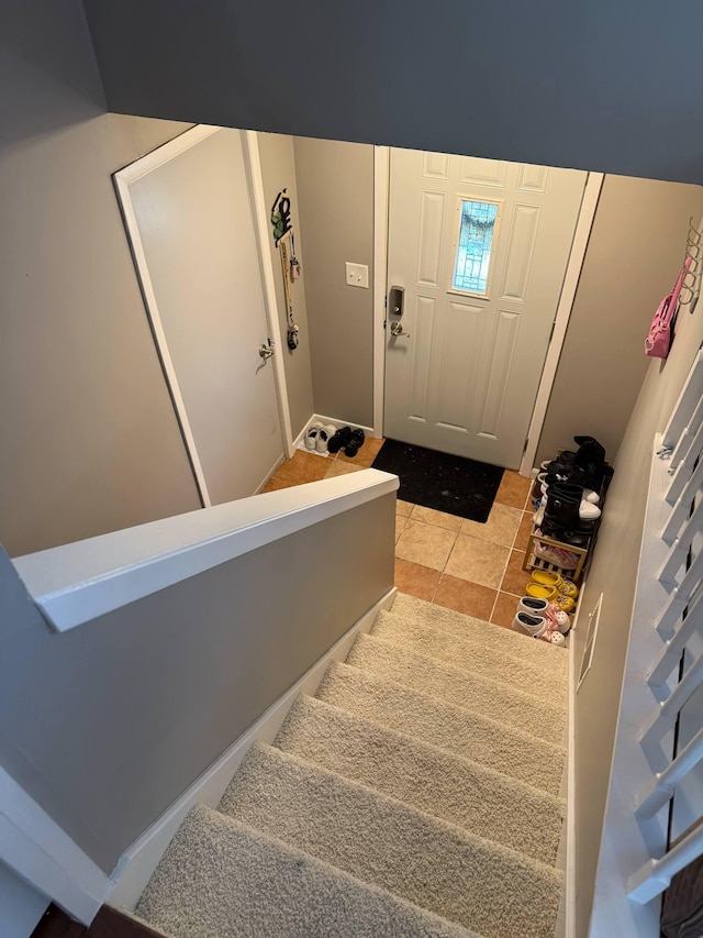 stairs with tile patterned floors
