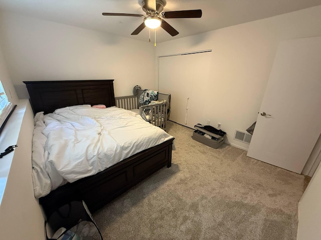 bedroom featuring light carpet and ceiling fan