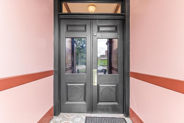 property entrance with french doors and stucco siding