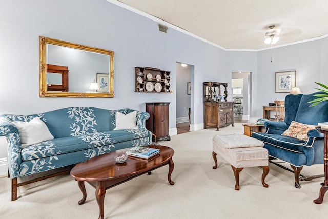 living room with ornamental molding, carpet floors, a ceiling fan, and baseboards