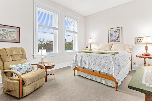 bedroom with carpet floors and baseboards
