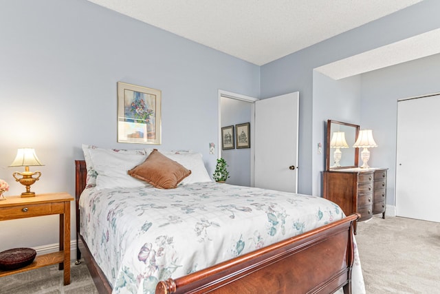 bedroom with carpet floors, baseboards, and a closet