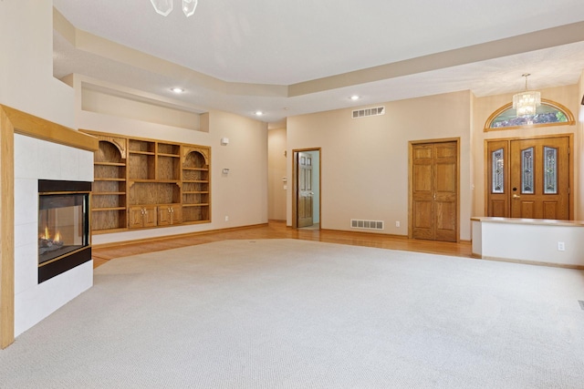 12124 Bluebird Cir NW, Coon Rapids, MN 55448 - unfurnished living room featuring light carpet, recessed lighting, a chandelier, baseboards, and a tile fireplace