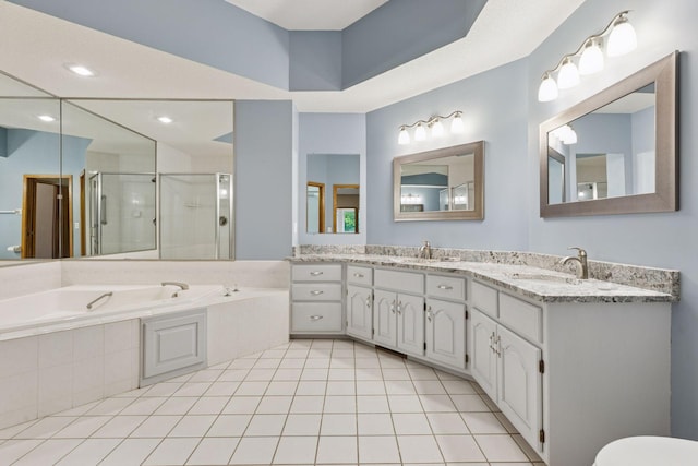 12124 Bluebird Cir NW, Coon Rapids, MN 55448 - full bath with a shower stall, a garden tub, tile patterned floors, double vanity, and recessed lighting