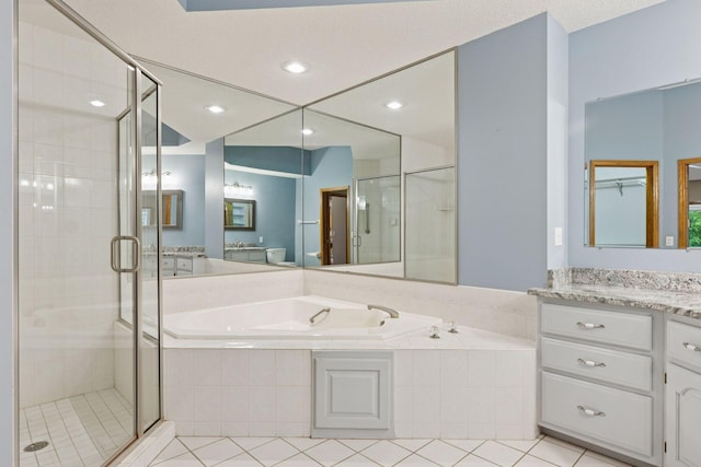 12124 Bluebird Cir NW, Coon Rapids, MN 55448 - bathroom featuring a garden tub, a shower stall, vanity, and tile patterned flooring