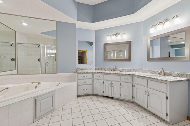 12124 Bluebird Cir NW, Coon Rapids, MN 55448 - bathroom featuring a stall shower, a bath, tile patterned floors, and double vanity